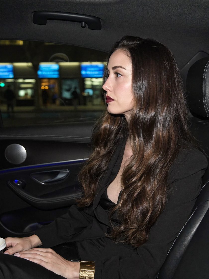 Shanté Micah in black, in the back seat of a car at night